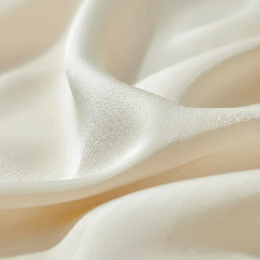 Close-up of beige fabric with AMII branding