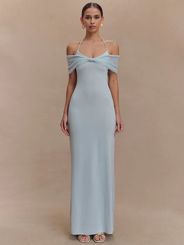 Woman wearing a light blue gown against a beige background