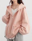Person wearing a pink jacket on a white background