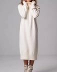 White sweater dress worn by a person on a gray background