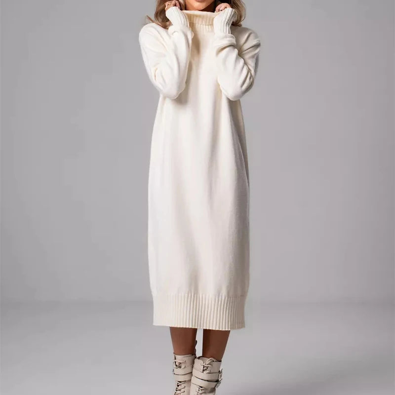 White sweater dress worn by a person on a gray background