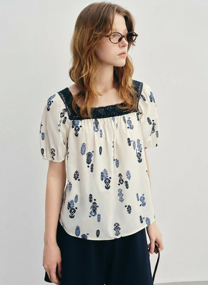 Woman wearing a floral blouse with a plain background