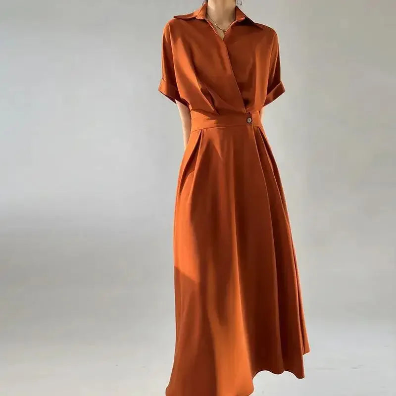 Orange dress on a mannequin against a plain background