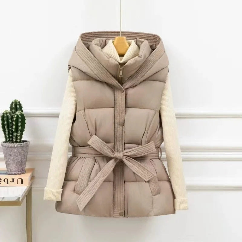Beige puffer vest with a belt on a white background