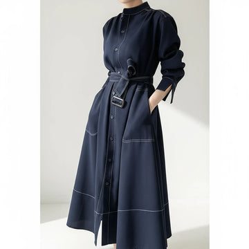 Navy blue dress with a belt on a plain background