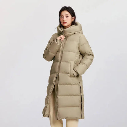 Woman wearing a long beige puffer coat on a light gray background