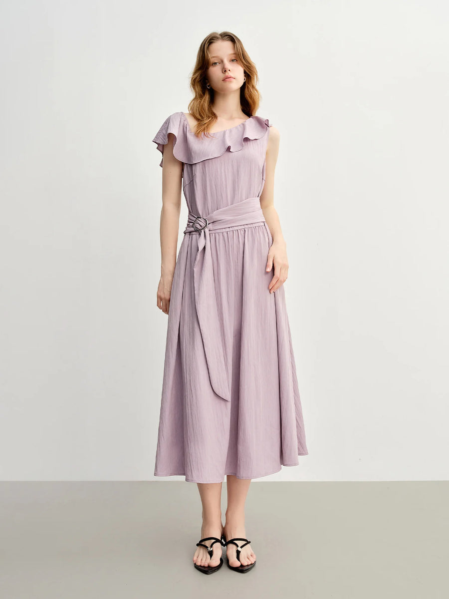 Woman wearing a light purple dress with ruffled collar on a white background