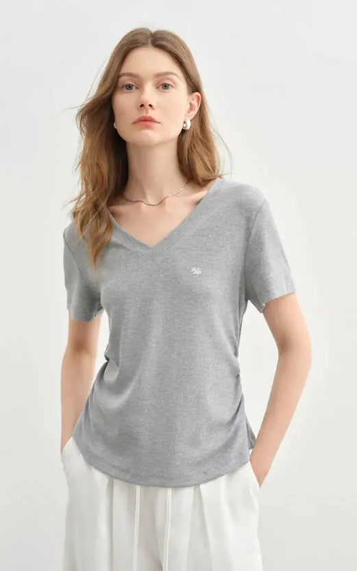 Woman wearing a gray t-shirt with a white background