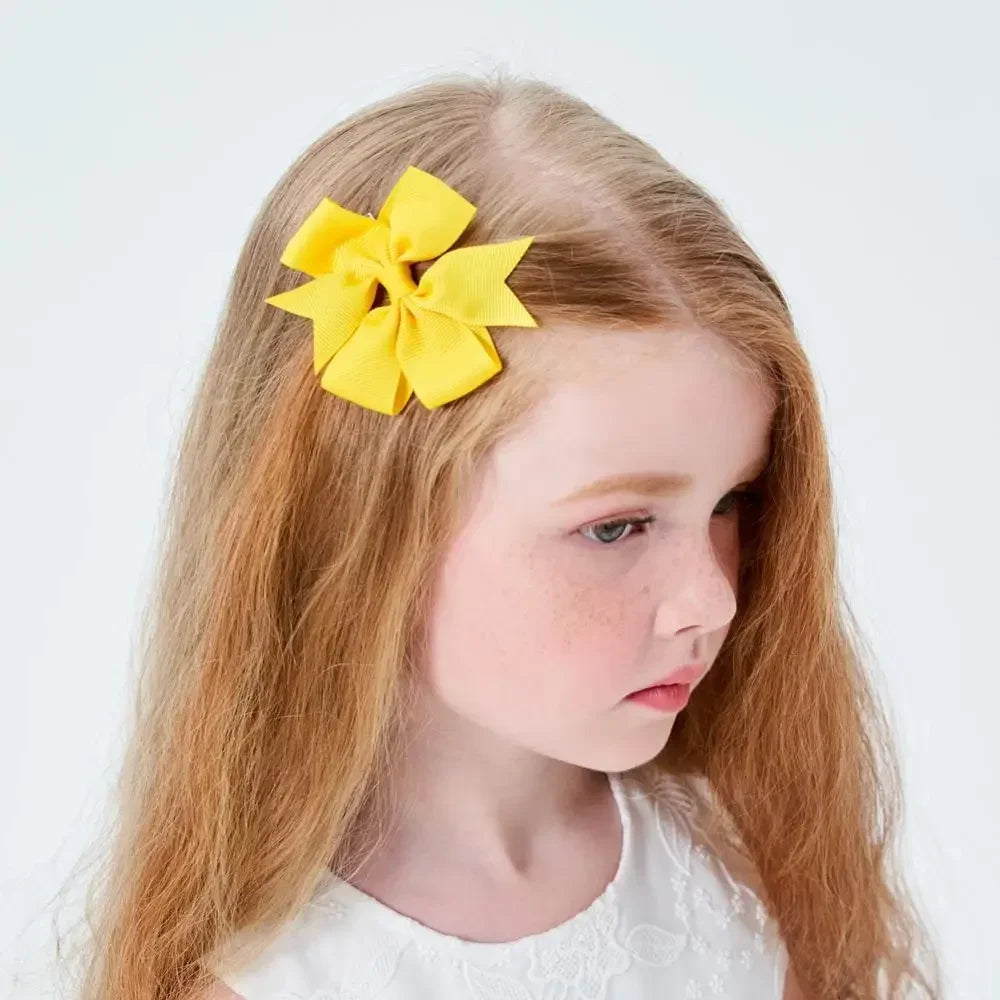 Young girl with a yellow hair accessory on a white background