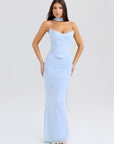 Woman wearing a light blue one-shoulder gown on a white background