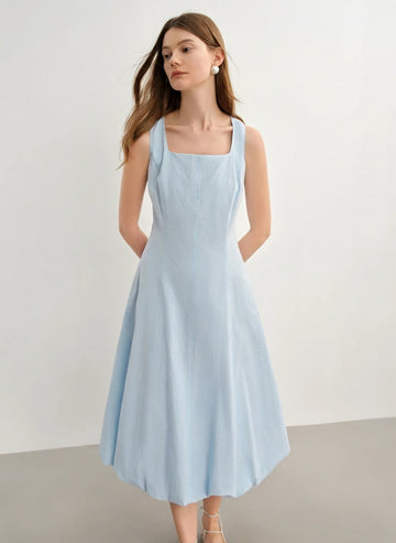 Woman wearing a light blue dress against a plain background with 'DUSHU' branding.