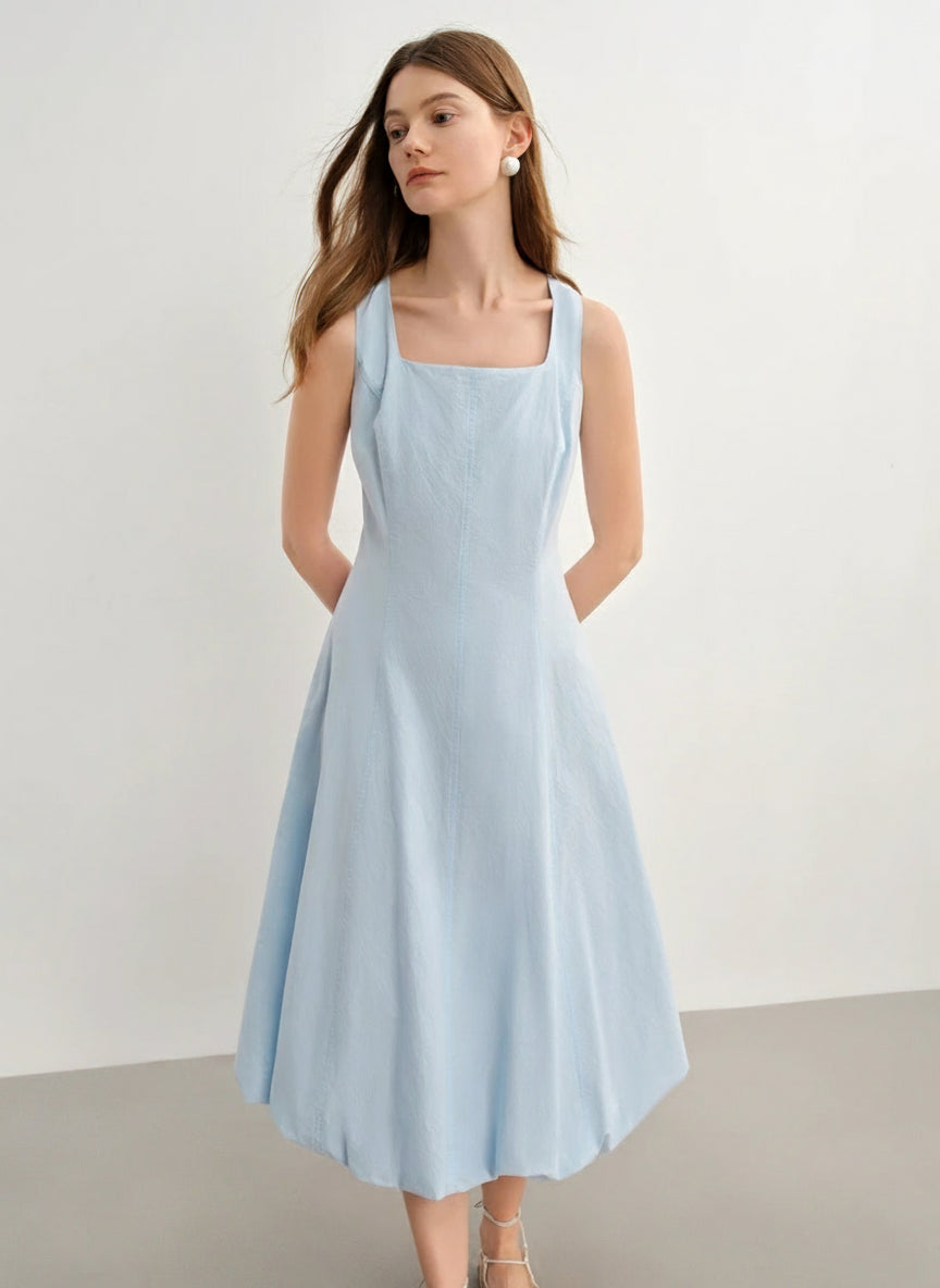 Woman wearing a light blue dress against a plain background with 'DUSHU' branding.