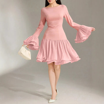 Pink dress with flared sleeves on a model against a neutral background