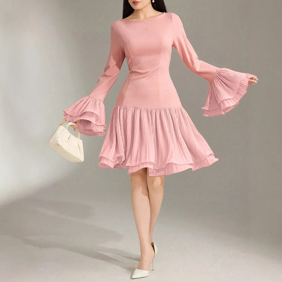 Pink dress with flared sleeves on a model against a neutral background